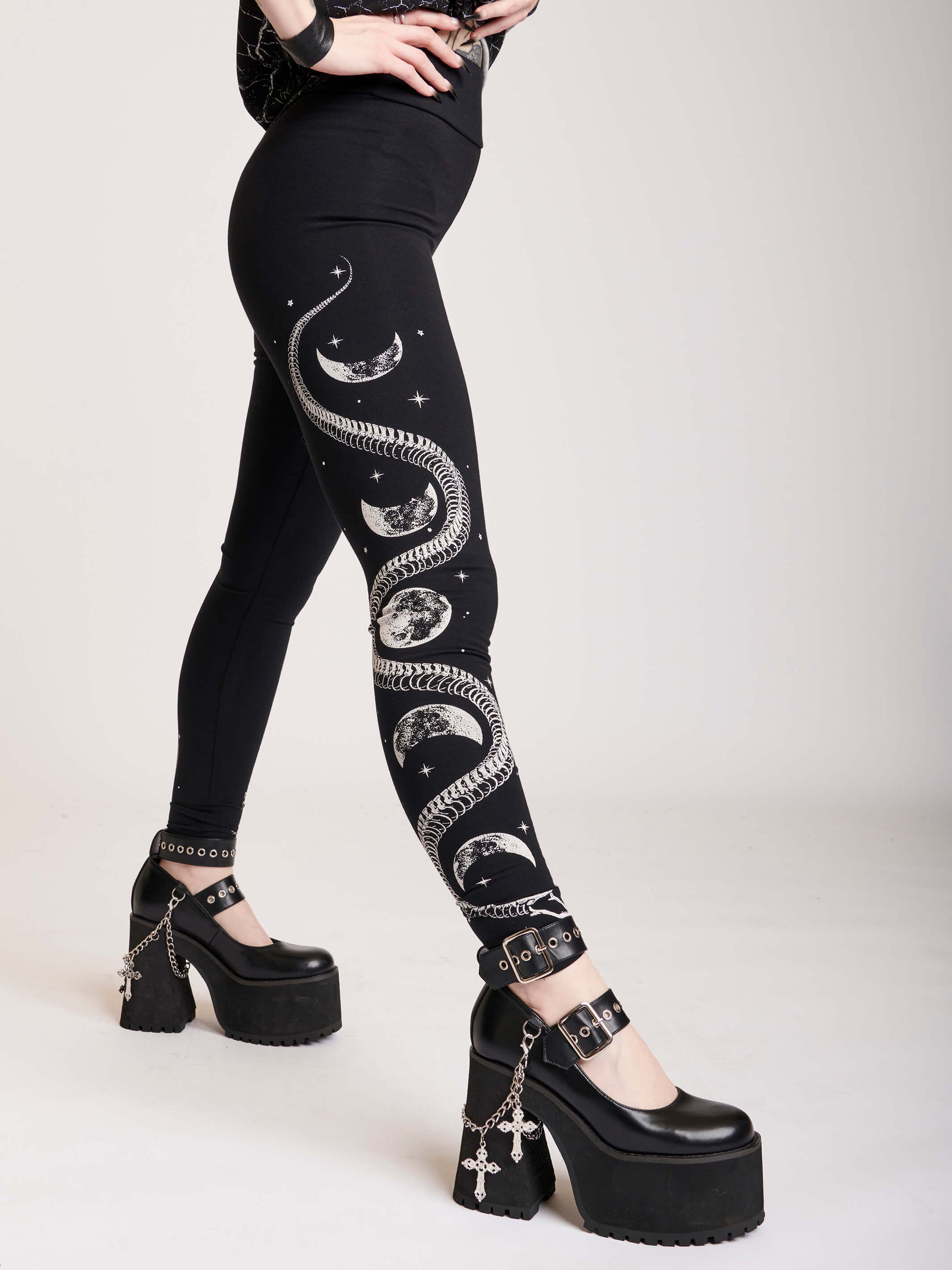 Black legging with skeleton snake and moon phase graphibs down the sides.