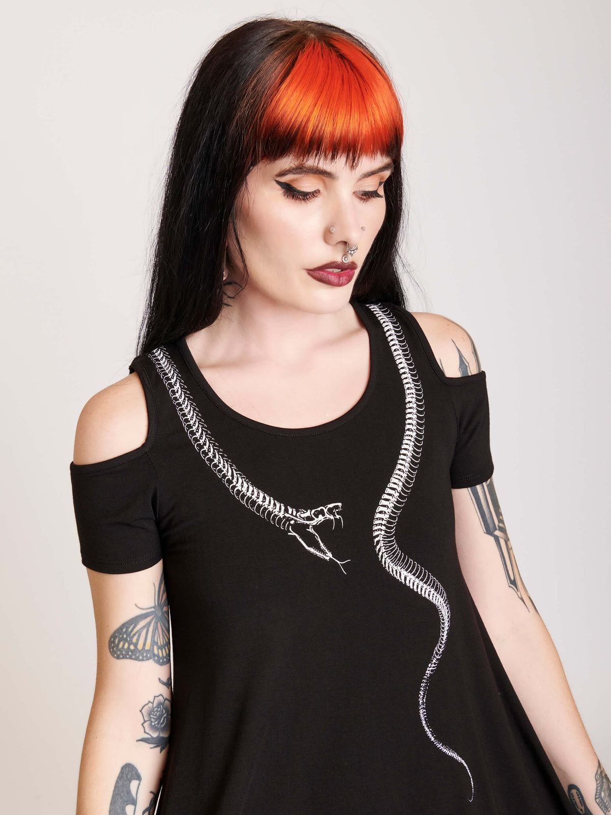 Black dress with skeleton snake art around the neckline