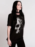 A black t-shirt with a large white skull graphic on the front.