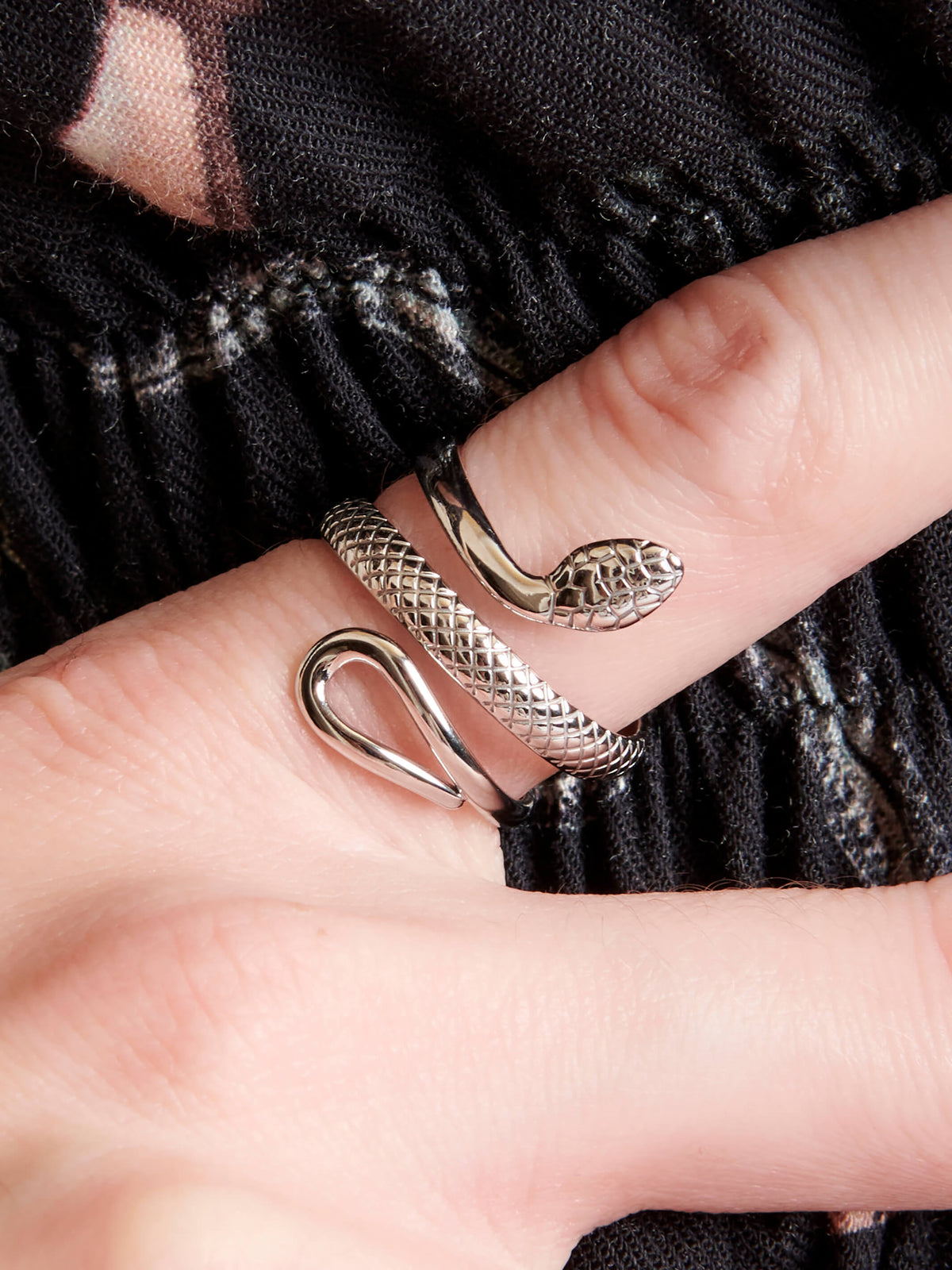 Silver snake wrapping around finger