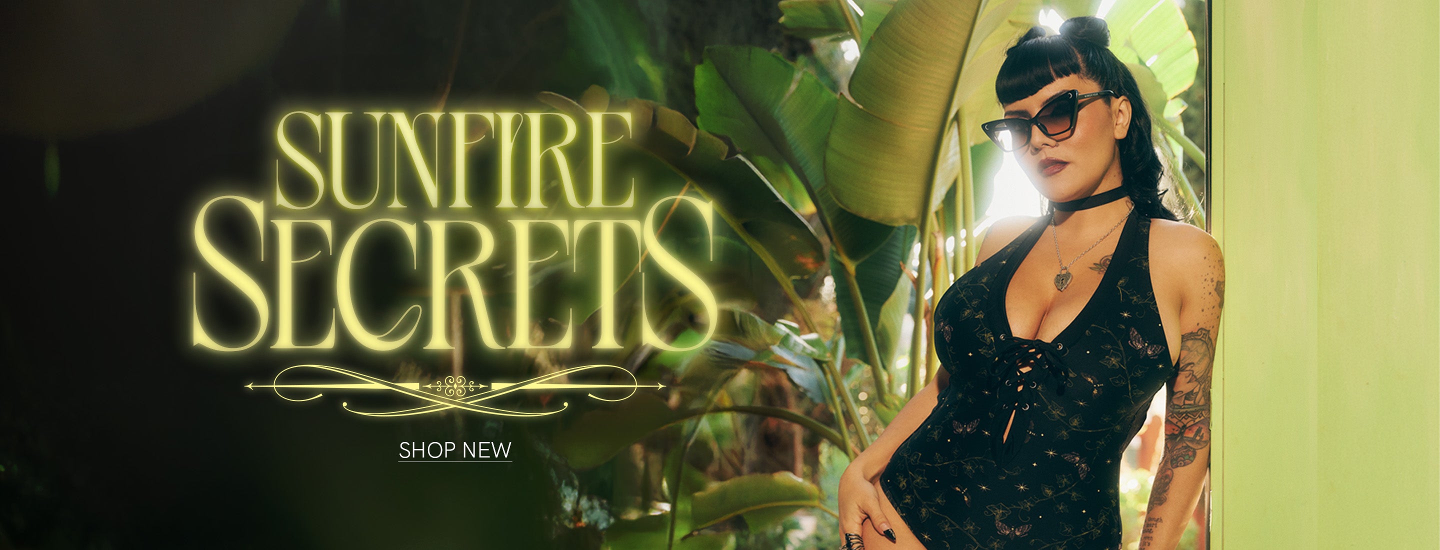 Woman in a black dress and sunglasses with 'Sunfire Secrets' neon sign in a tropical setting