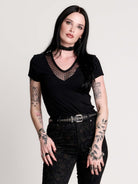 a black short-sleeve V-neck t-shirt featuring a sheer polka-dot mesh panel at the neckline