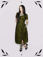 a short-sleeved olive green midi dress with a gothic pattern
