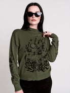 an olive green mock-neck sweater featuring a black gothic graphic