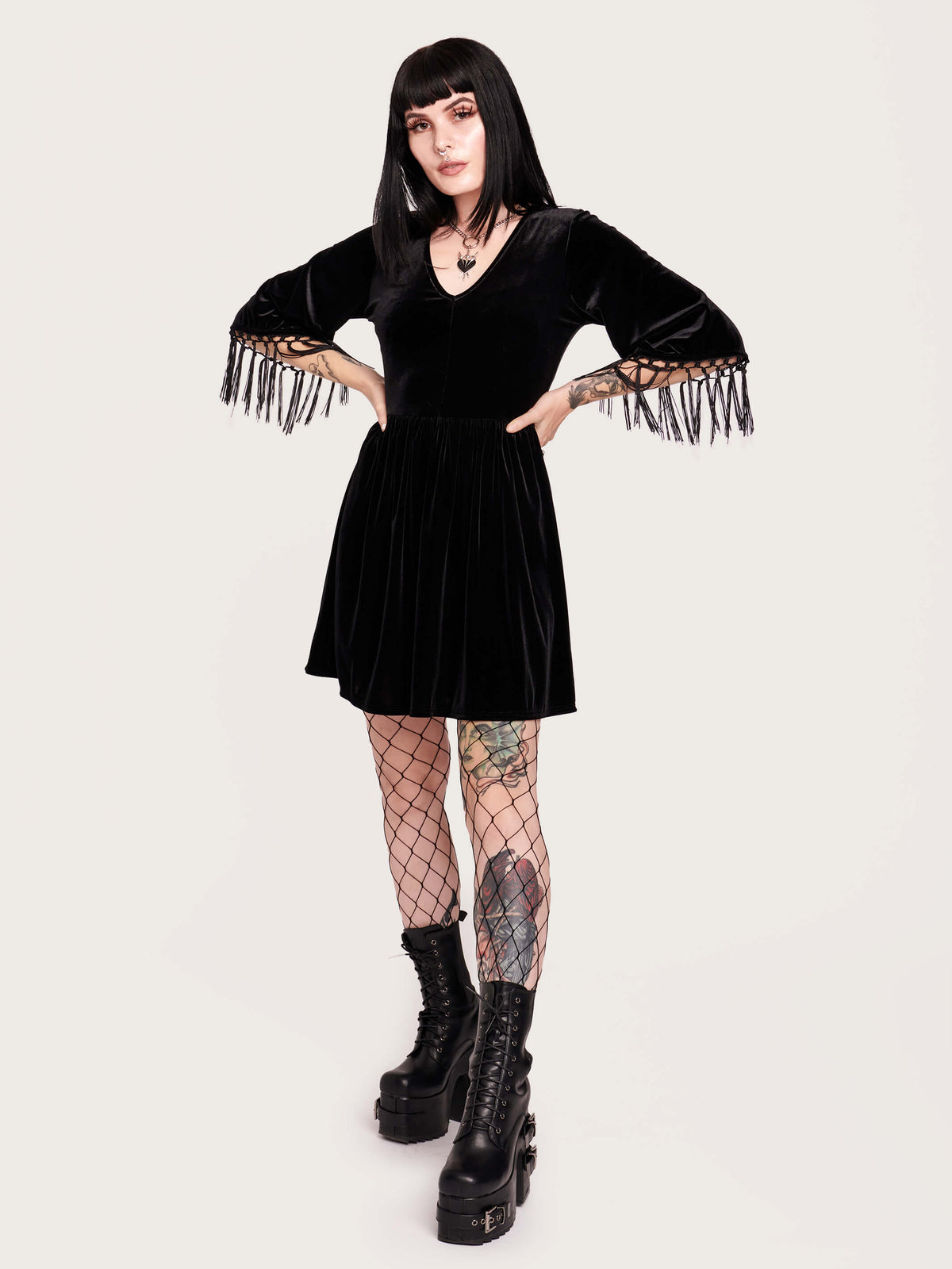Good witch or bad witch? Day or evening? You decide when you wear our stretch velvet dress with fringe details on the sleeves. Stretch elastic at waist. Goth grunge fashion, alt girl fashion, goth clothing, gothic dress, black velvet dress, egirl fashion, emo fashion