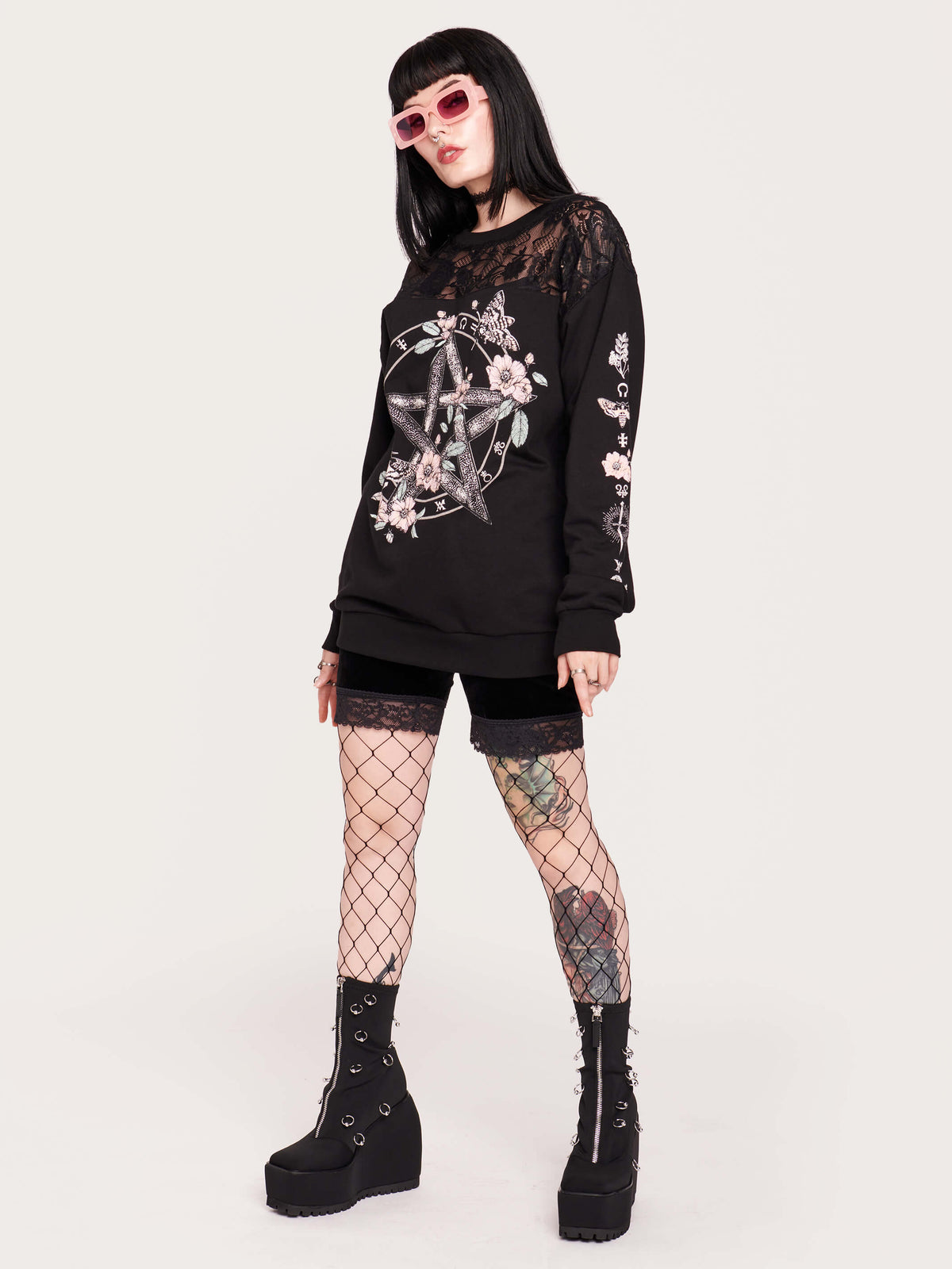 black sweatshirt featuring a deathmoth, pentacle, and magic herbs on the front and arms with black fishnet yoke in front and back.