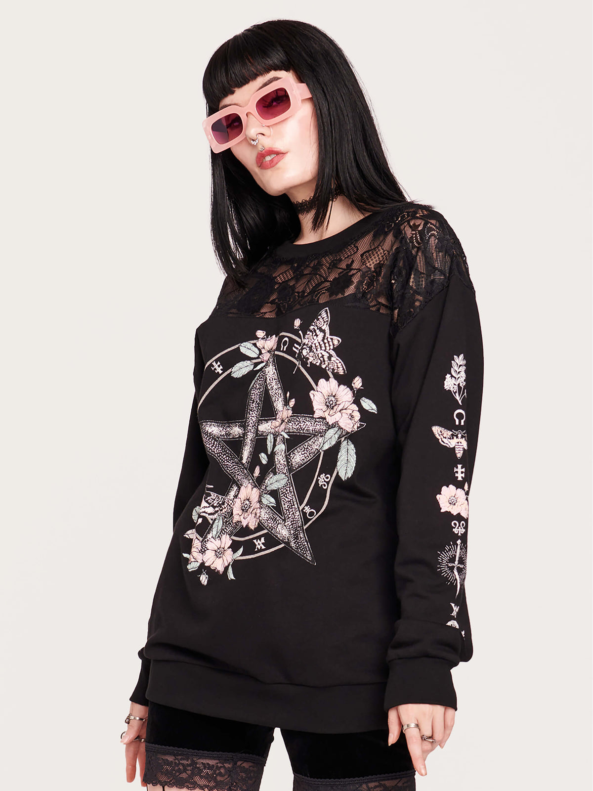  black sweatshirt featuring a deathmoth, pentacle, and magic herbs on the front and arms with black fishnet yoke in front and back. 