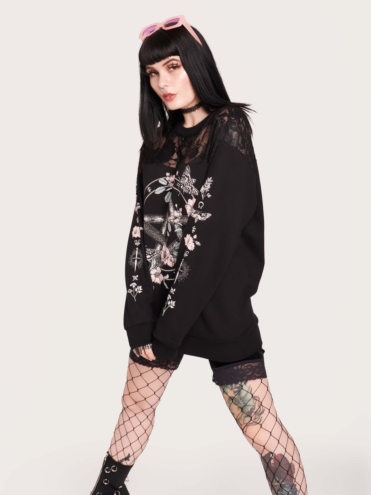 black sweatshirt featuring a deathmoth, pentacle, and magic herbs on the front and arms with black fishnet yoke in front and back.