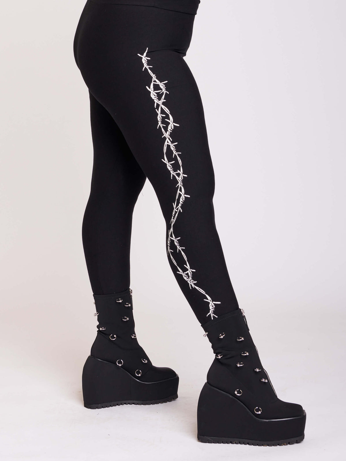 Black leggings with side bardbed wire graphic