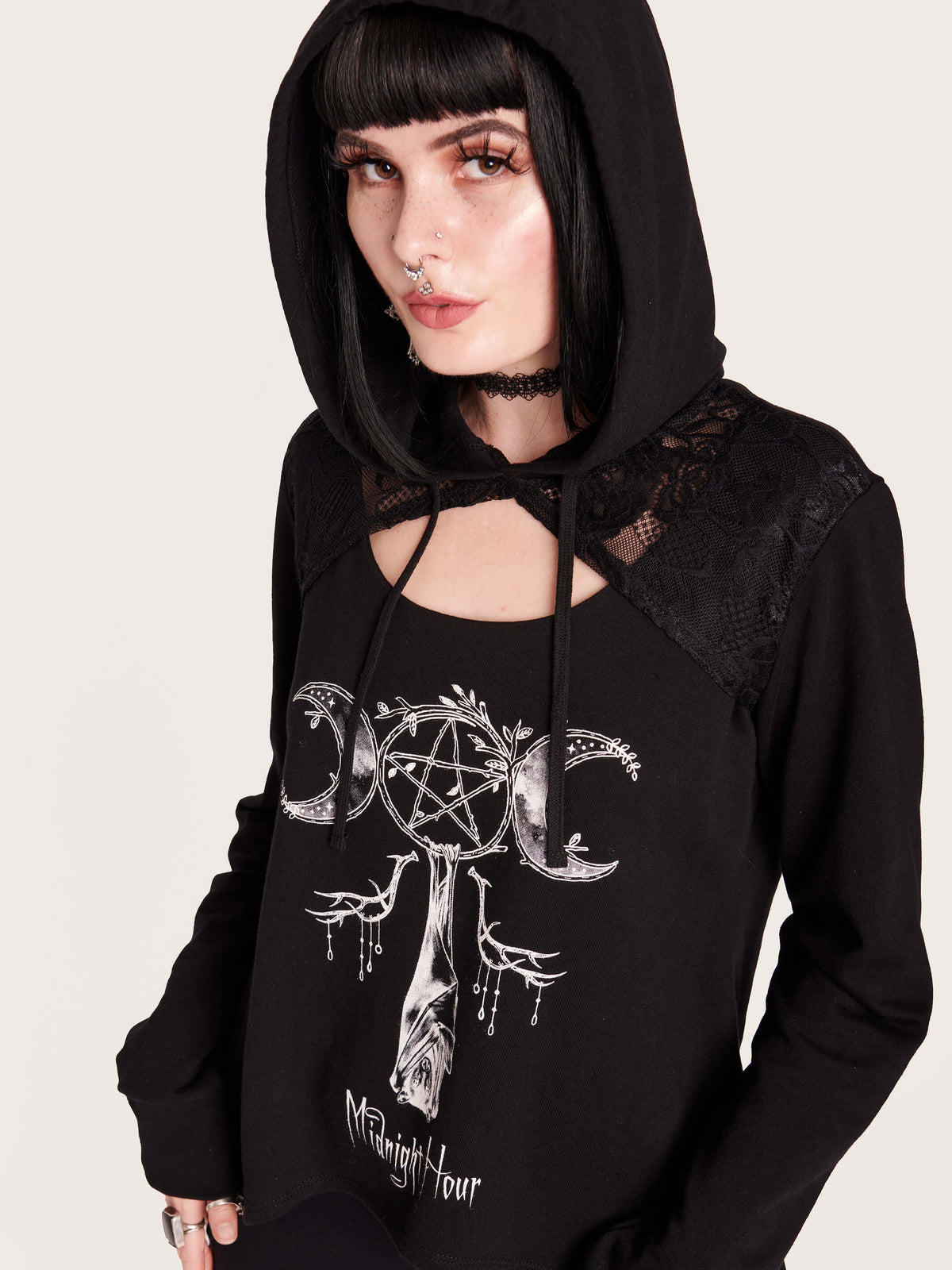 Be the hush of the night with this assymetrical hem, lace keyhole hoodie. Featuring our moon goddess sleeping bat graphic with black lace details. 100% cotton hoodie with nylon spandex lace details. witchy vibes, forest goth, bat, moon phase, crescent noon, pentacle, black lace, hoodie, nugoth, black goth, goth girl, bat girl. dark aesthetic, alt fashion.