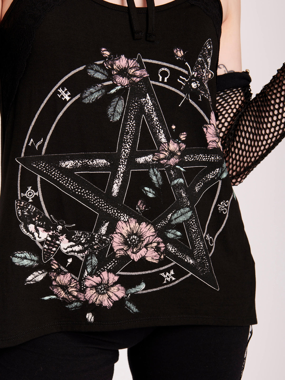 It&#39;s a hot goth girl summer in our pentacle witchy tank. Pastel floral, moths, and witchy symbols with victorian lace detailing. Black gothic tank top. Stand out from the masses with this beautifully crafted tank with black lace details..