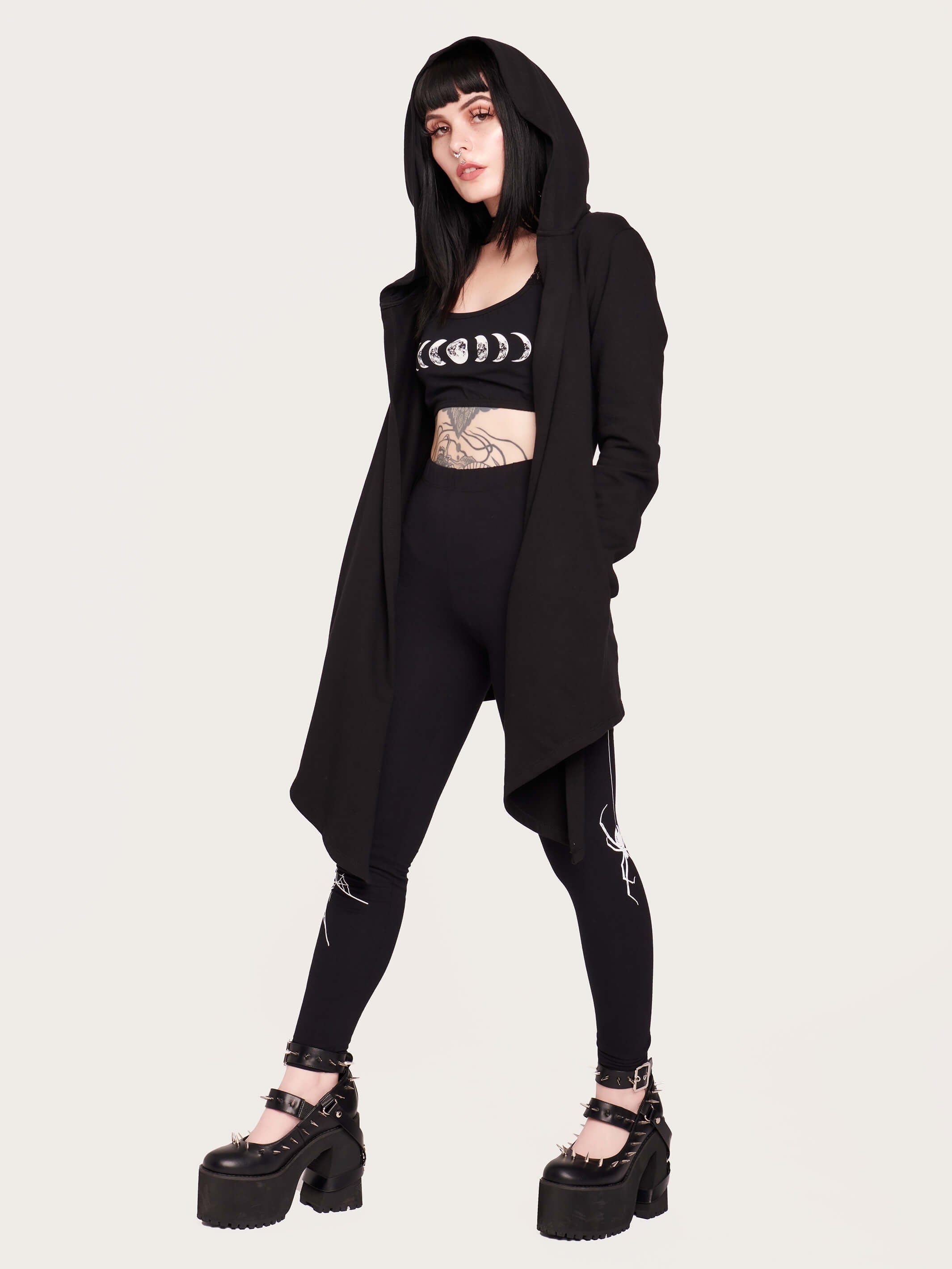 Tap into some voodoo vibes with this embroidered spinal back detail on our french terry hooded cloak. Crescent moon & rose embroidery on the front. Assymetrical hem with pockets. Goth grunge fashion, alt girl fashion, goth clothing, summer goth, skull top, goth punk top, egirl fashion, emo fashion.