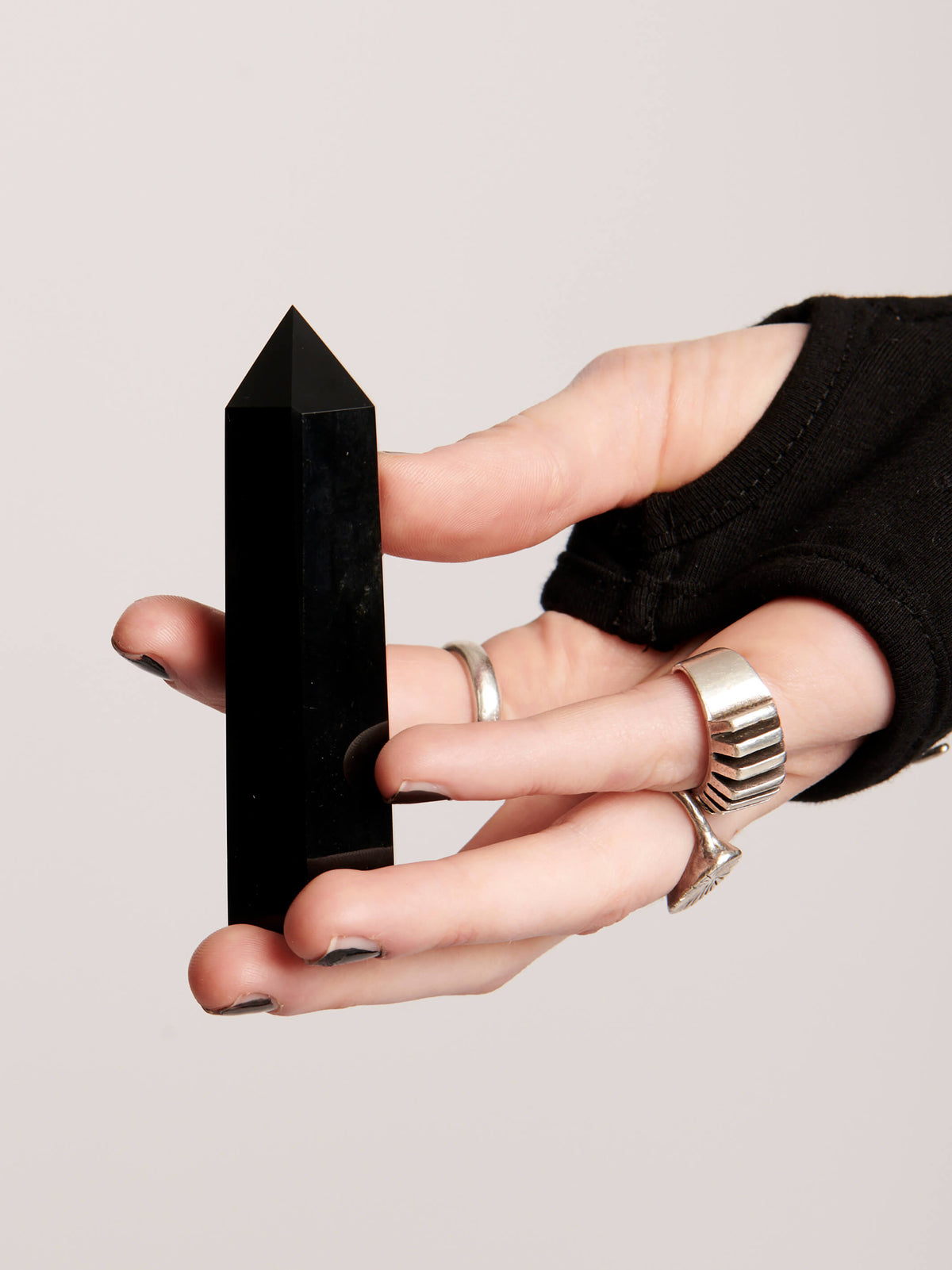 Black Obsidian crystal point. Smooth polished black stone with pointed tip.