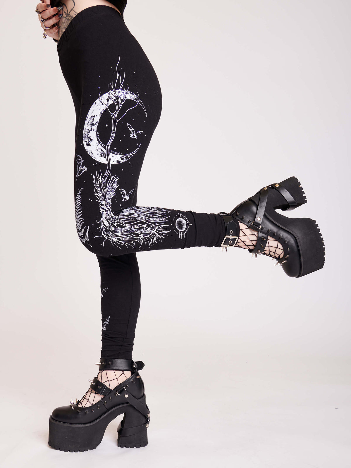 Witchy broom stick graphic on black leggings