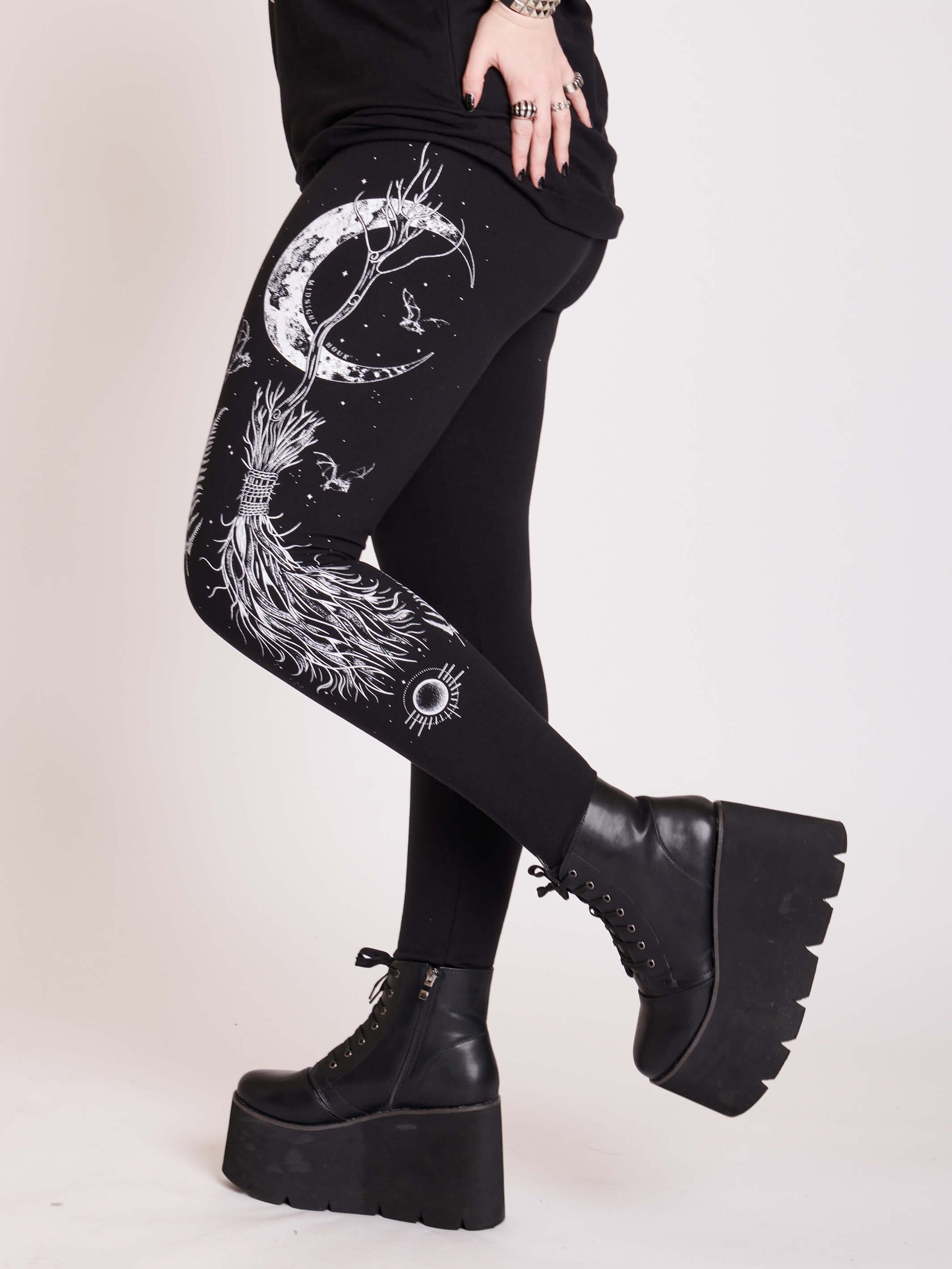 Witchy broom stick graphic on black leggings