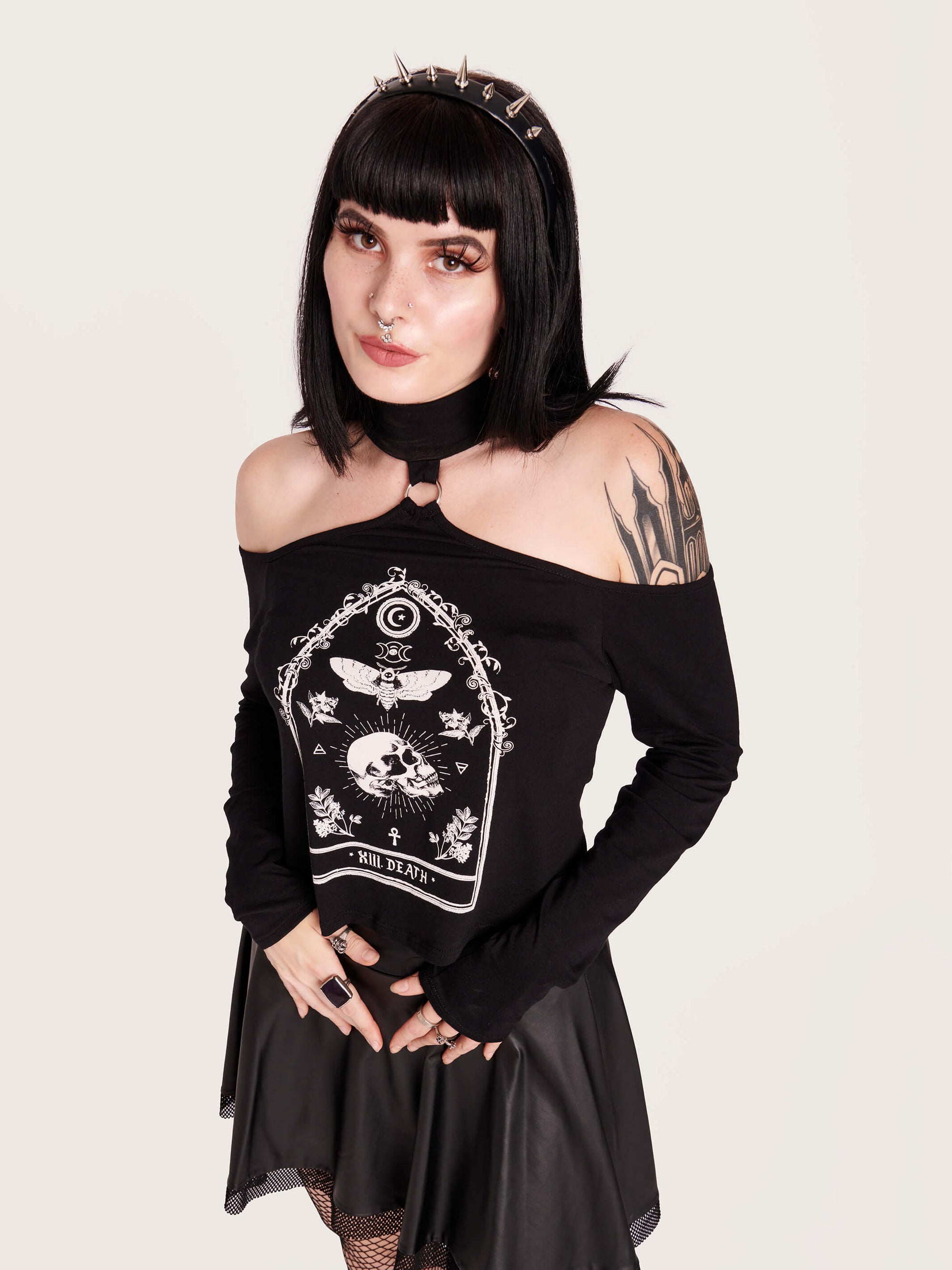  off the shoulder top with mock neck and metal o-ring details. Featuring Death tarot card art.