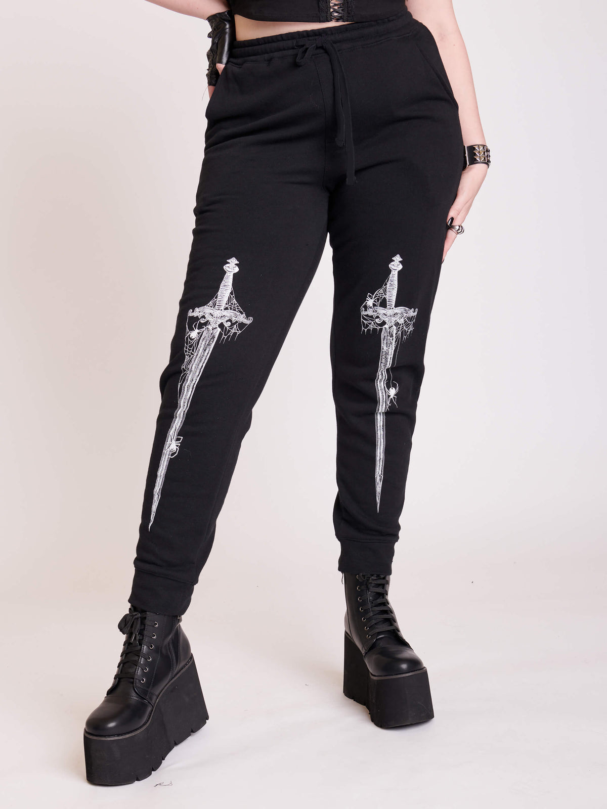 black joggers with dagger graphic
