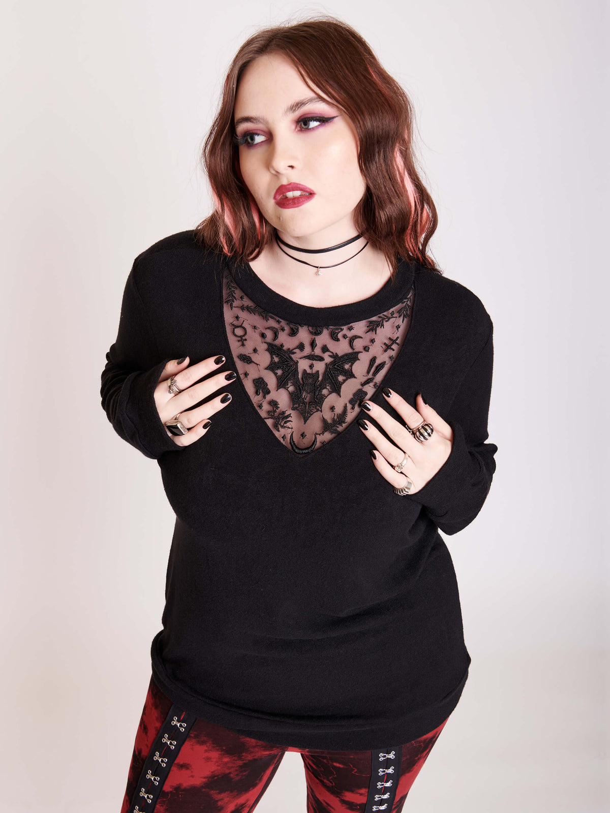 embroidered bat detail on black long sleeve top