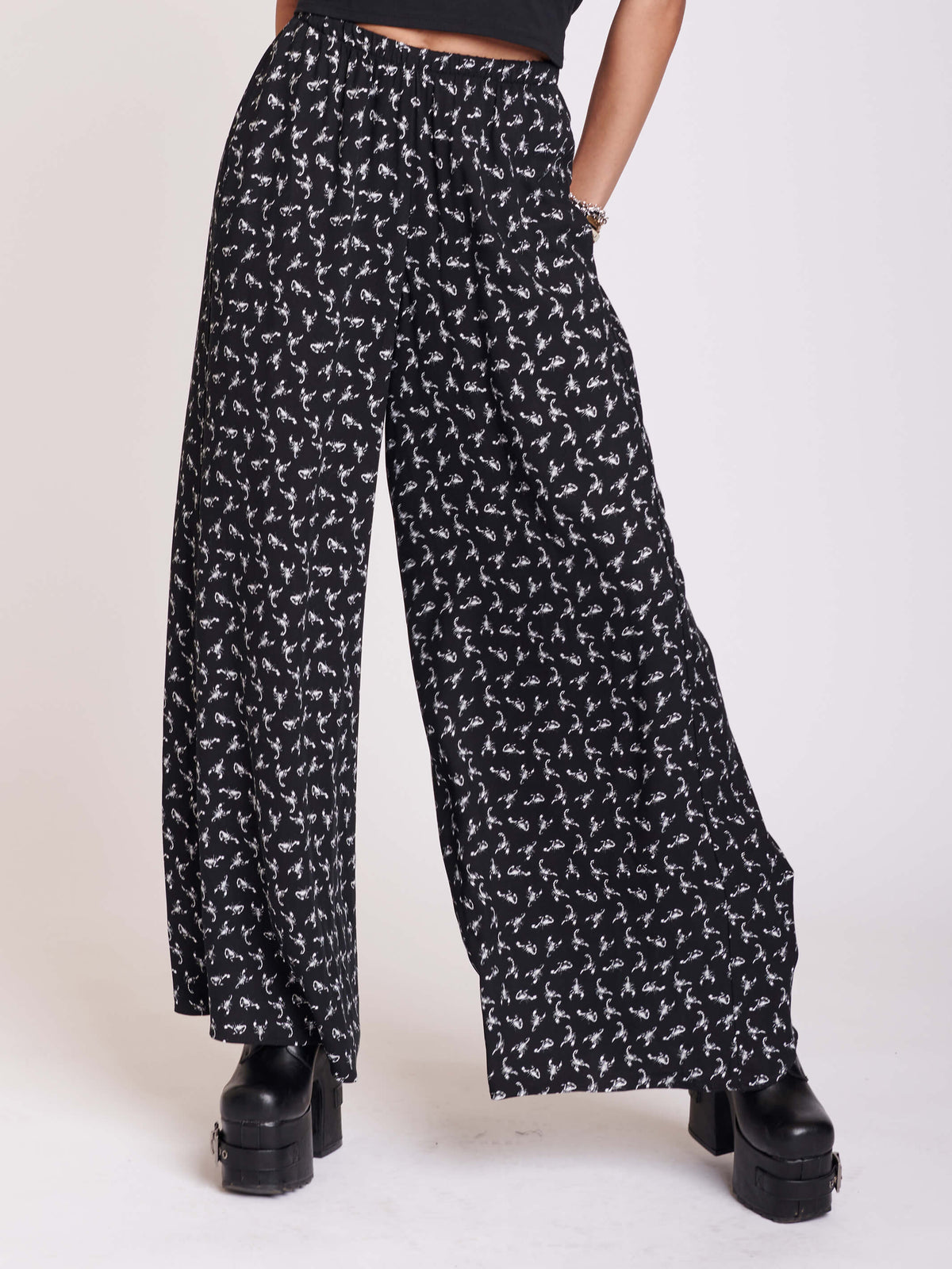 Black palazzo pants with all over scorpian print