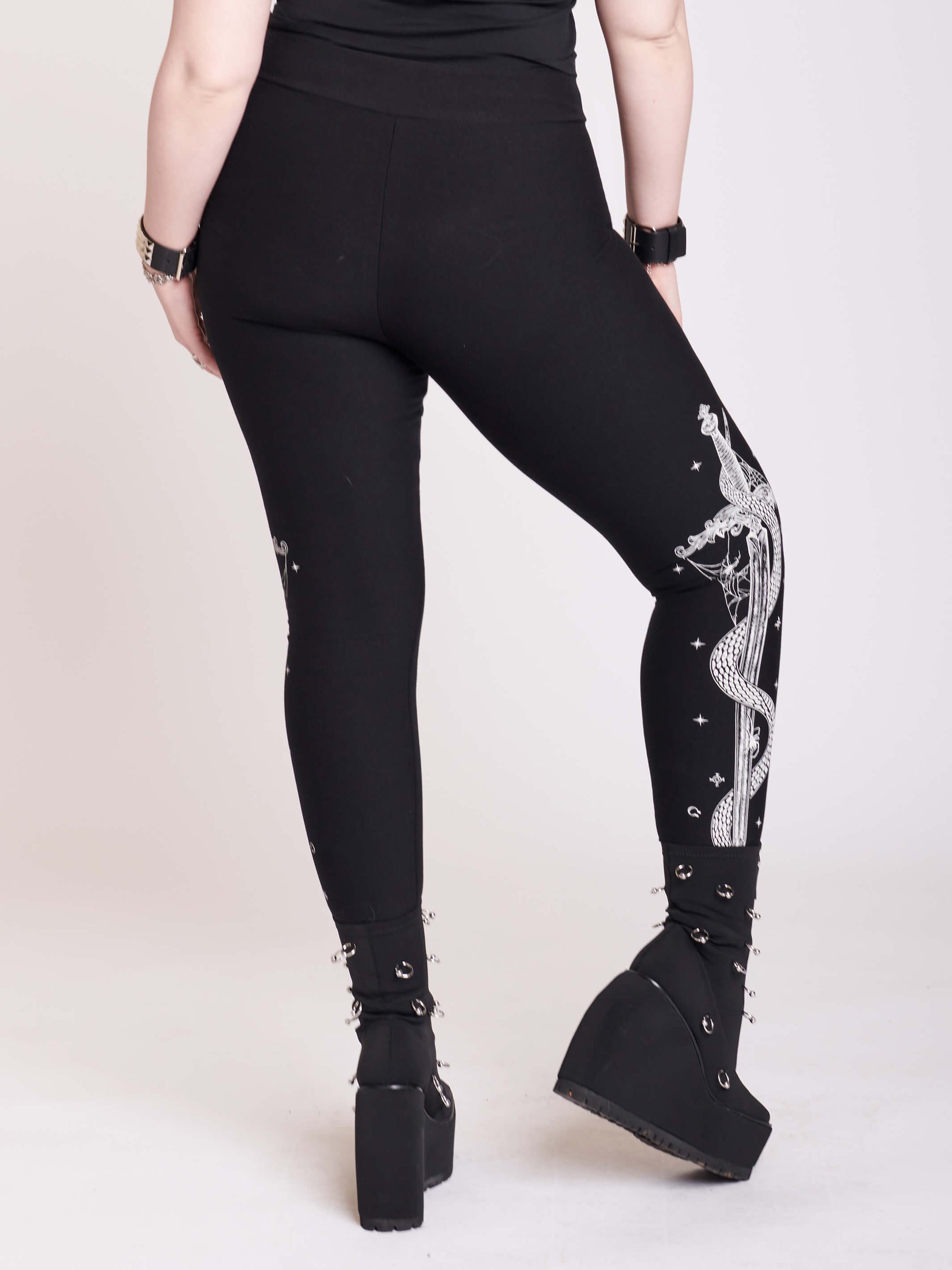 black legging with snake and dagger graphic on side